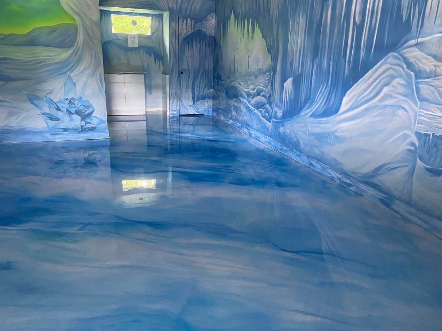 Blue metallic epoxy floor in a themed commercial space