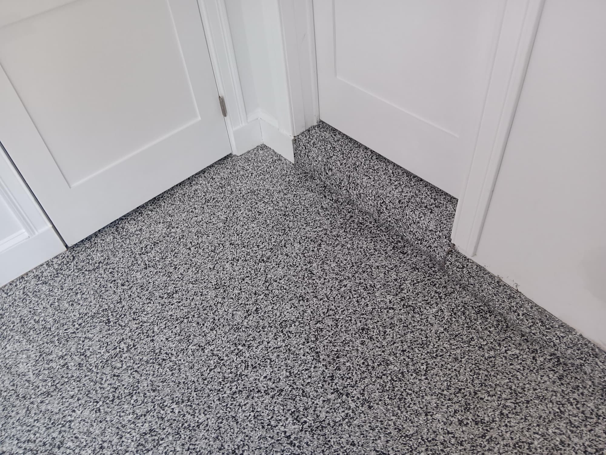 Flake floor detail with coved baseboard around door trim
