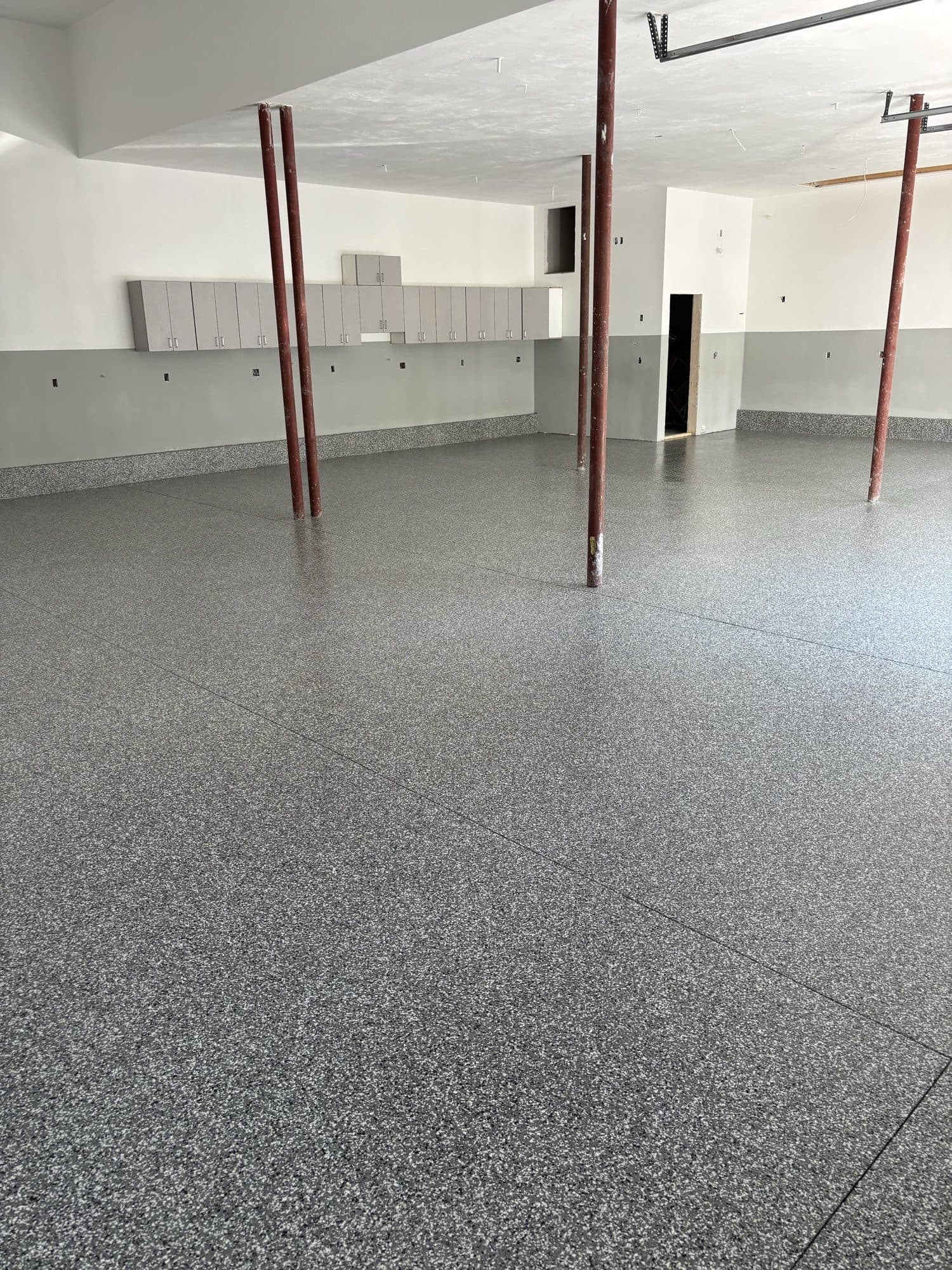 Large commercial floor coated with gray epoxy flake